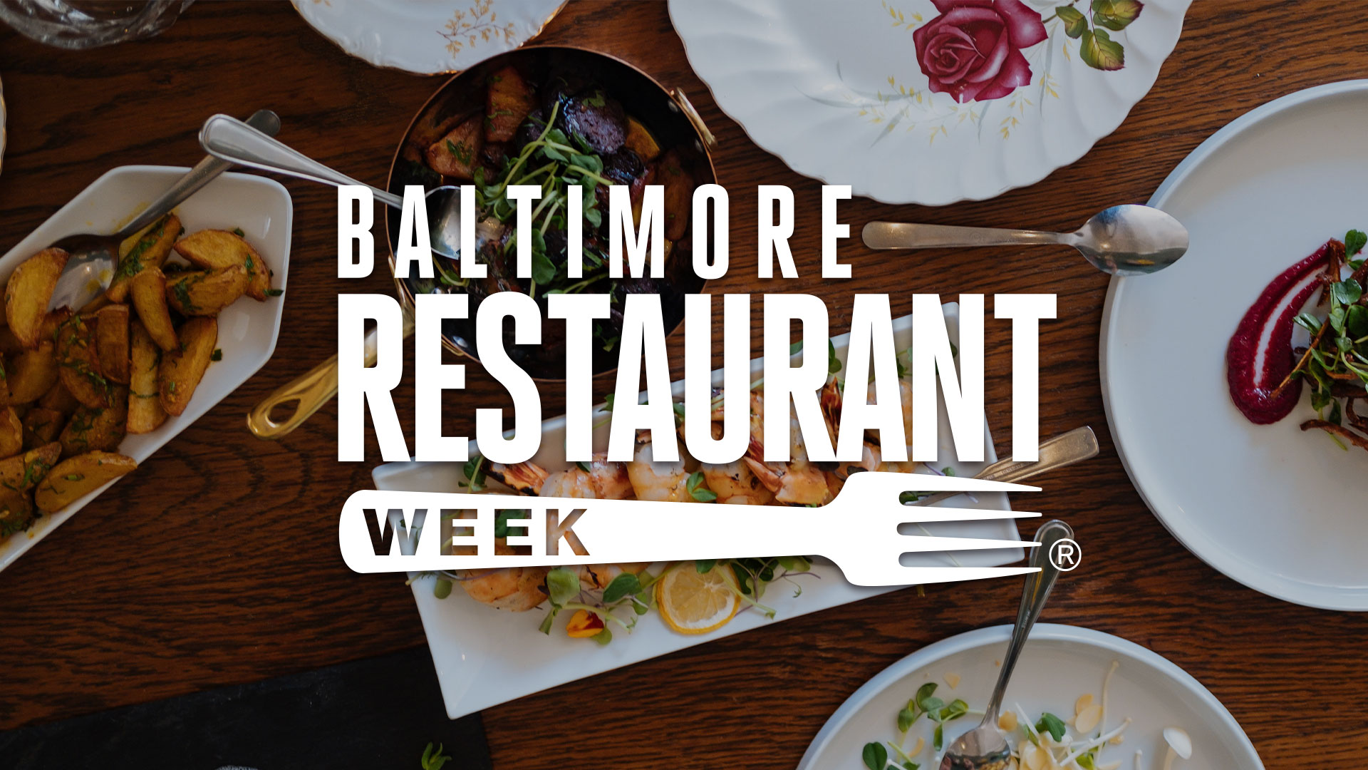 Baltimore Restaurant Week logo overlay on table of colorful food.