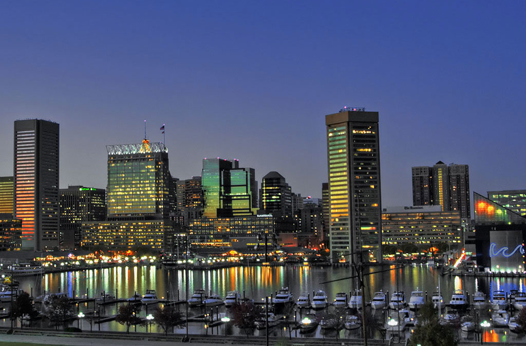 Baltimore Skyline and Inner Harbor area lit up at dusk.