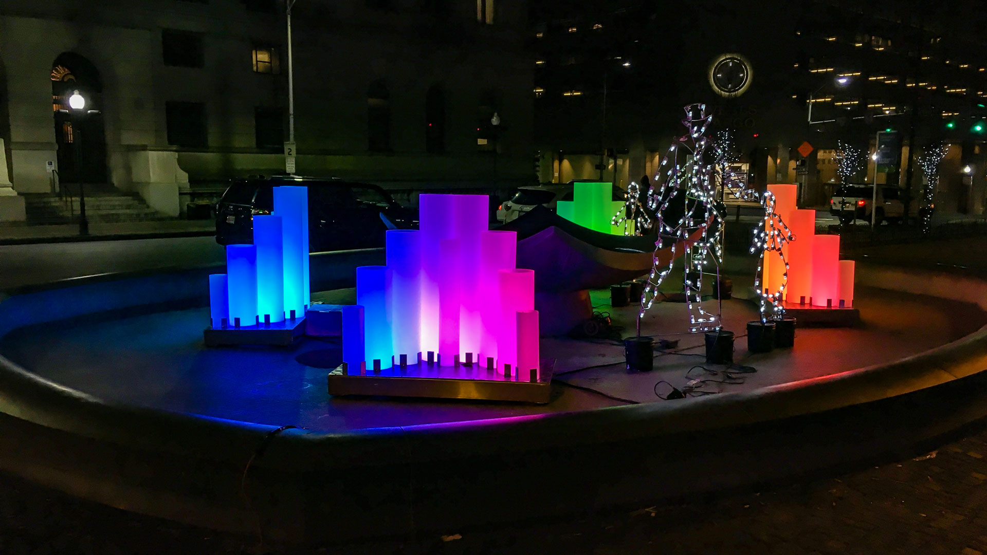 Downtown Baltimore plaza with fountain that features colorful light design.
