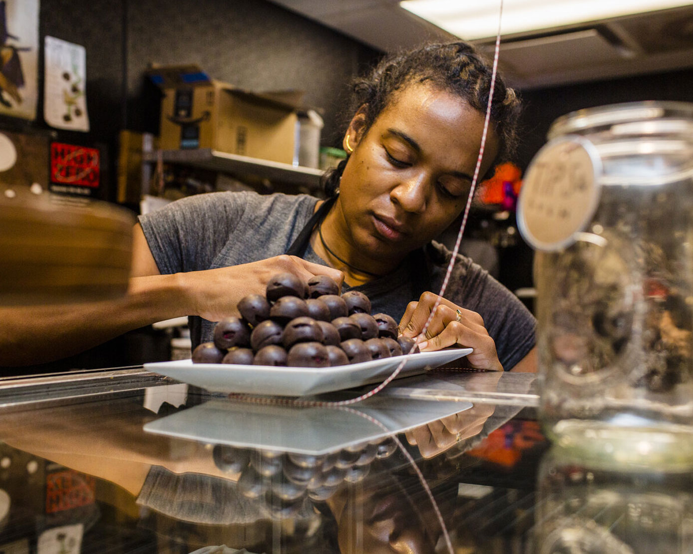 Chef and entrepreneur Jinji Fraser preparing chocolate truffles in her market shop in Baltimore.