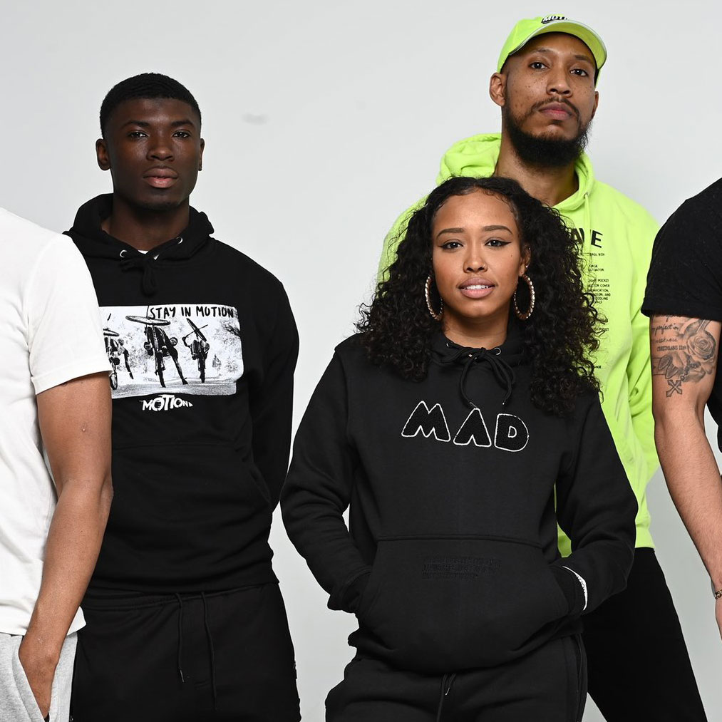 Male and female African American models in athletic clothing from Motion Athletics in Baltimore.