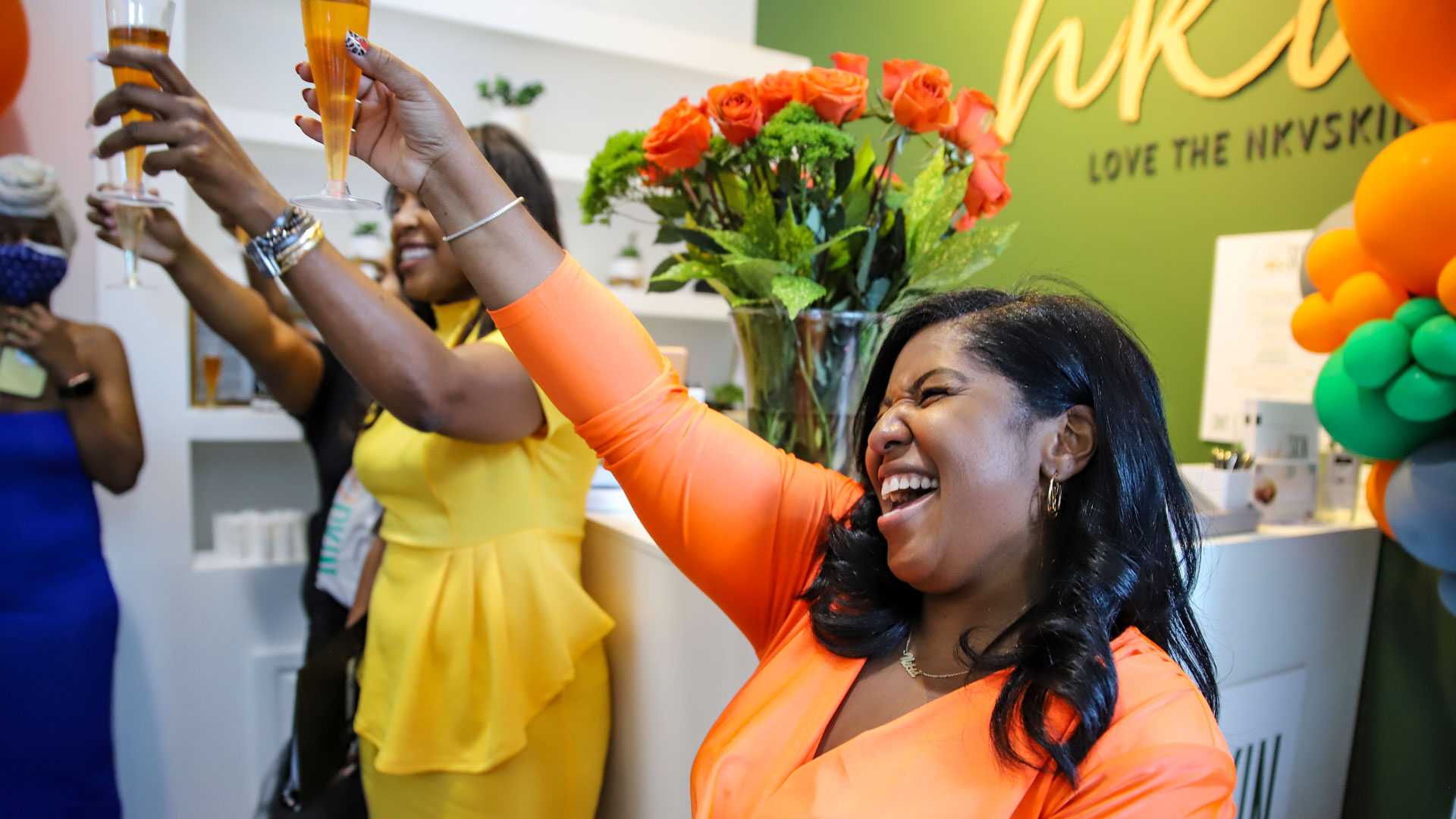Nikia Vaughan leads a toast to celebrate the grand opening of NKVSKIN.