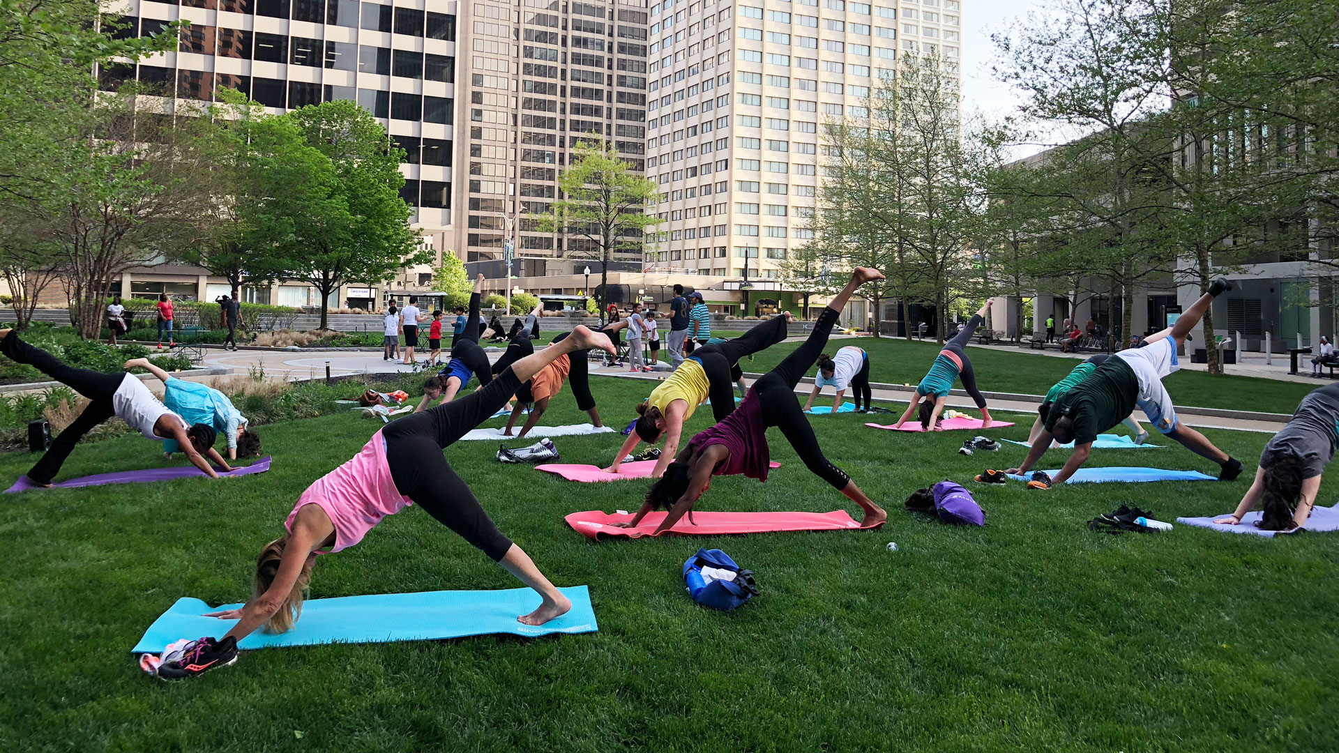 Group yoga class in grassy section of Center Plaza in Downtown Baltimore.